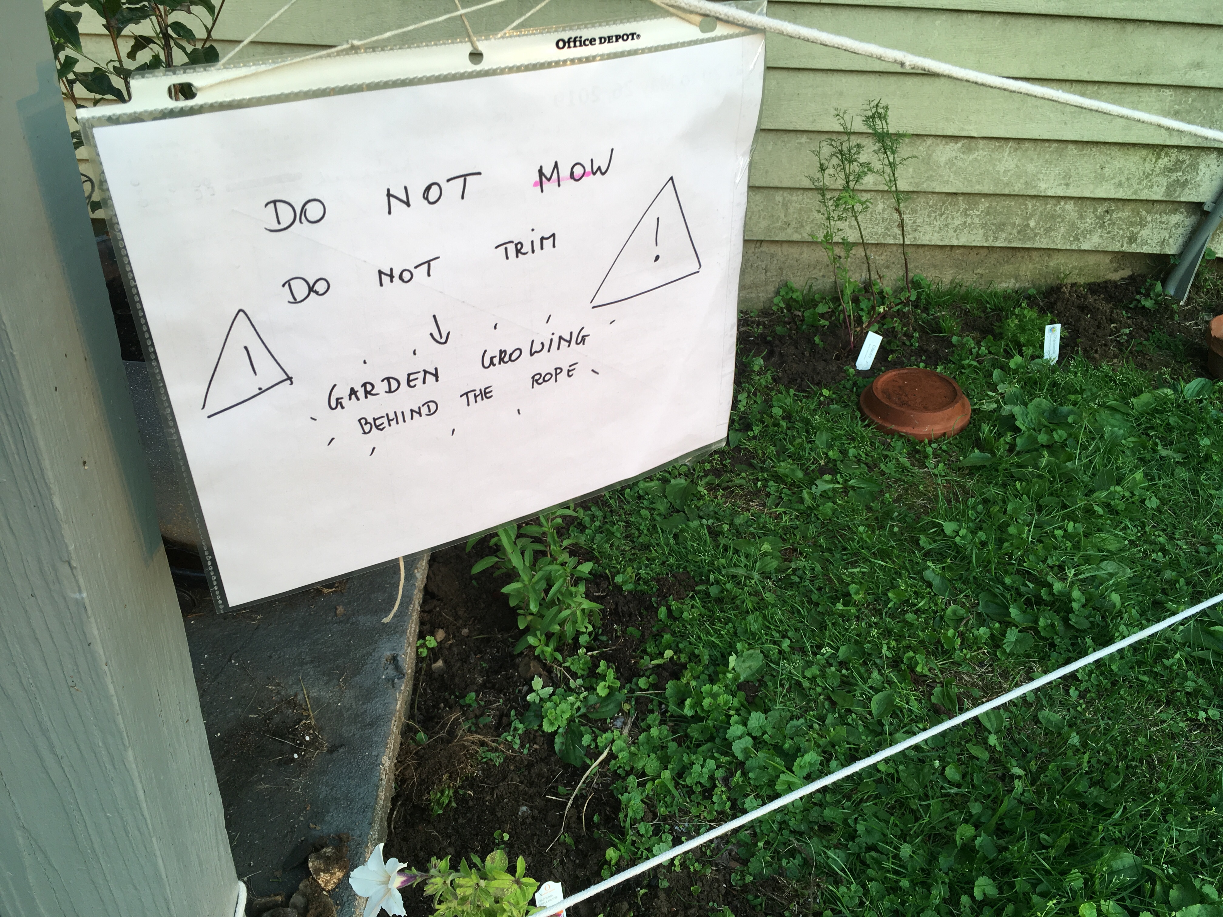 Handwritten sign to keep gardening crew out of newly planted area